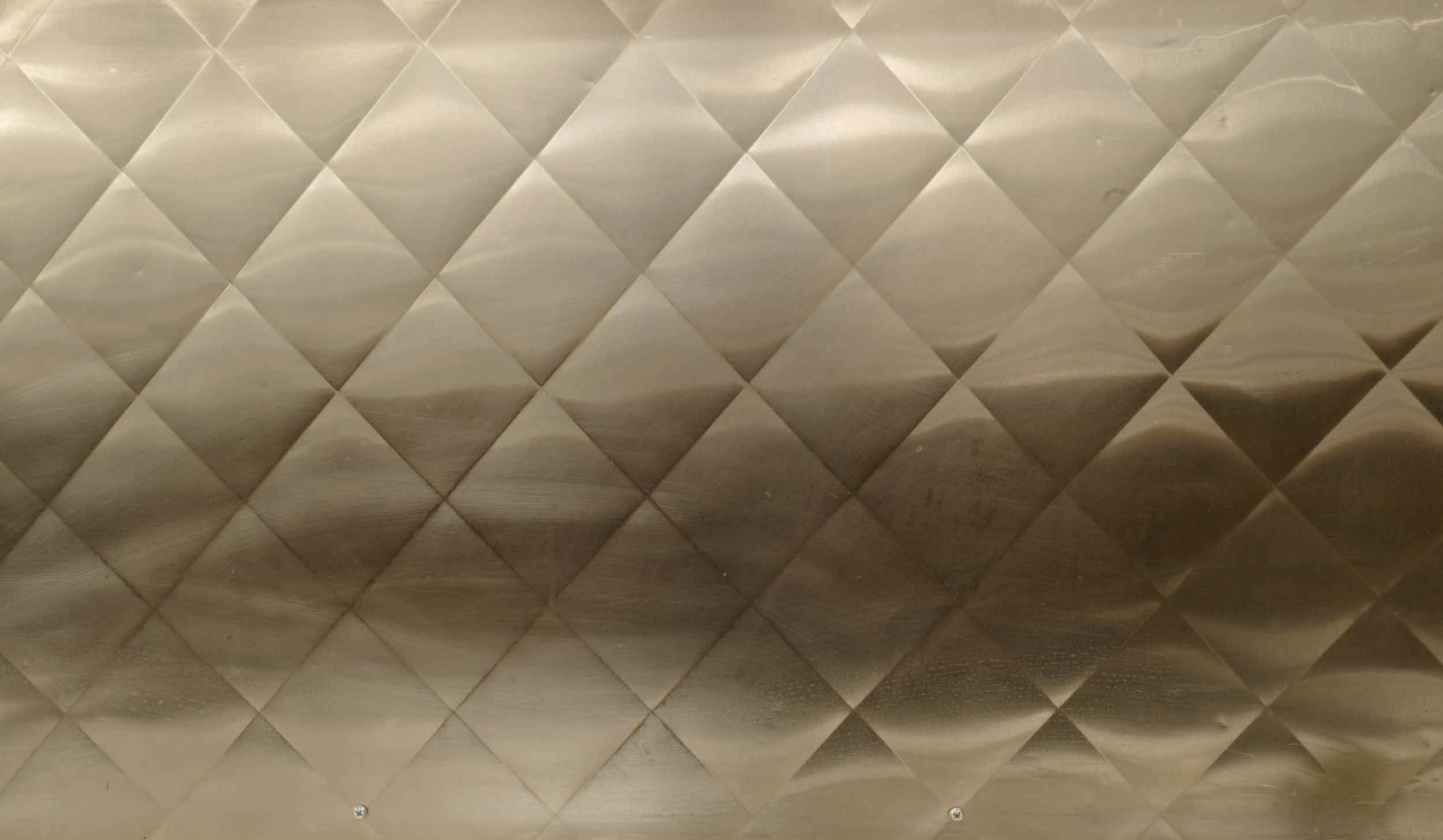 Commercial kitchen backsplash made of steel, pressed in a diamond pattern